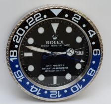 A 'Rolex' style advertising wall clock, black dial reads 'Rolex Oyster Perpetual Date GMT-Master