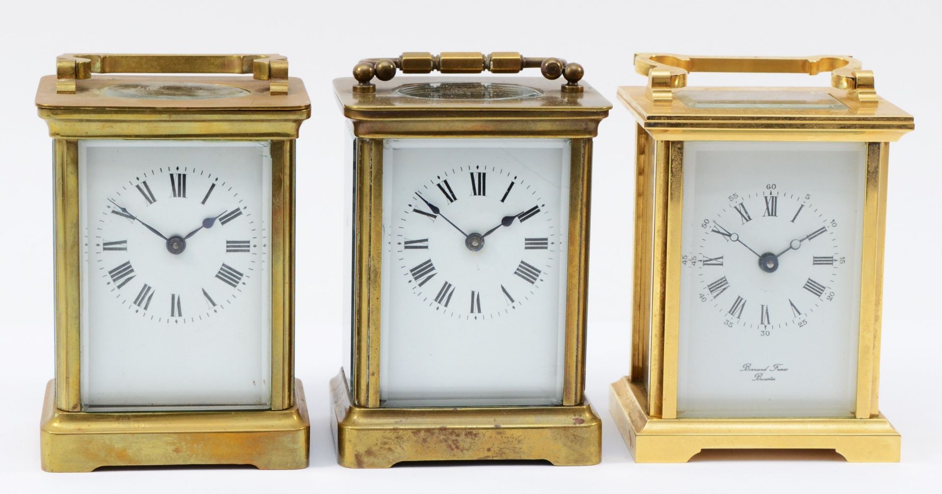 An English brass cased 8 day carriage clock, circa 1980s, together with two French examples. (3)