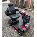 A four wheeled Envoy mobility scooter, complete with rear carrier, charger and keys.