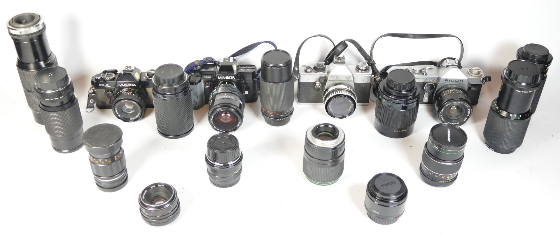 Four SLR vintage film cameras to include a Minolta 7000, a Praktica LTL, a Praktica TLS and and