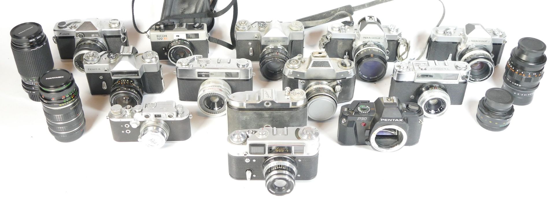 Thirteen SLR vintage film cameras to include a Zenit B, an EXA IIb, a Kowa SE, and a Ricoh 500RF.