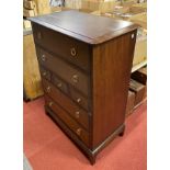 A Stag Minstrel tallboy/chest of drawers, having three small central drawers with two deep drawers