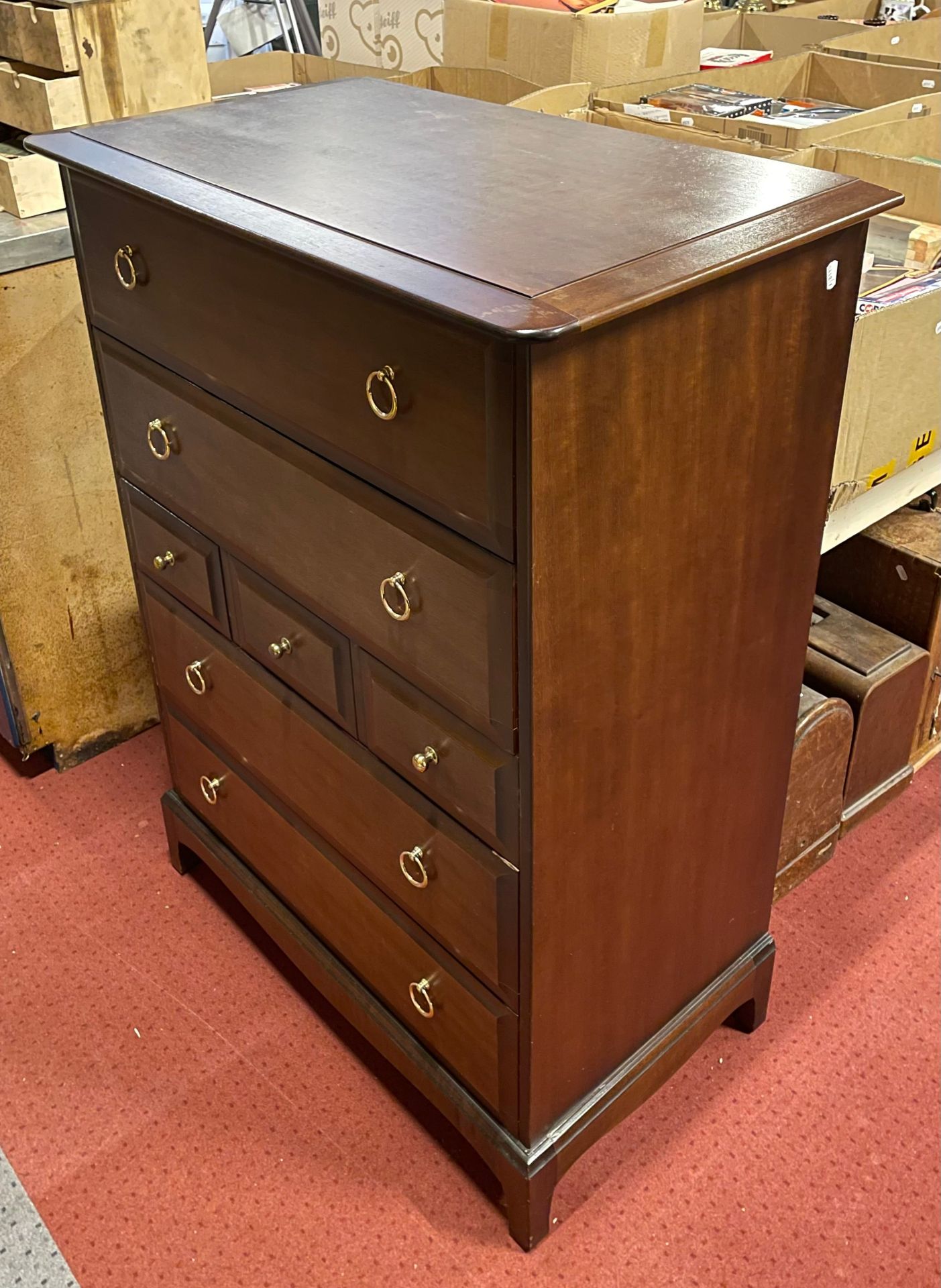 A Stag Minstrel tallboy/chest of drawers, having three small central drawers with two deep drawers
