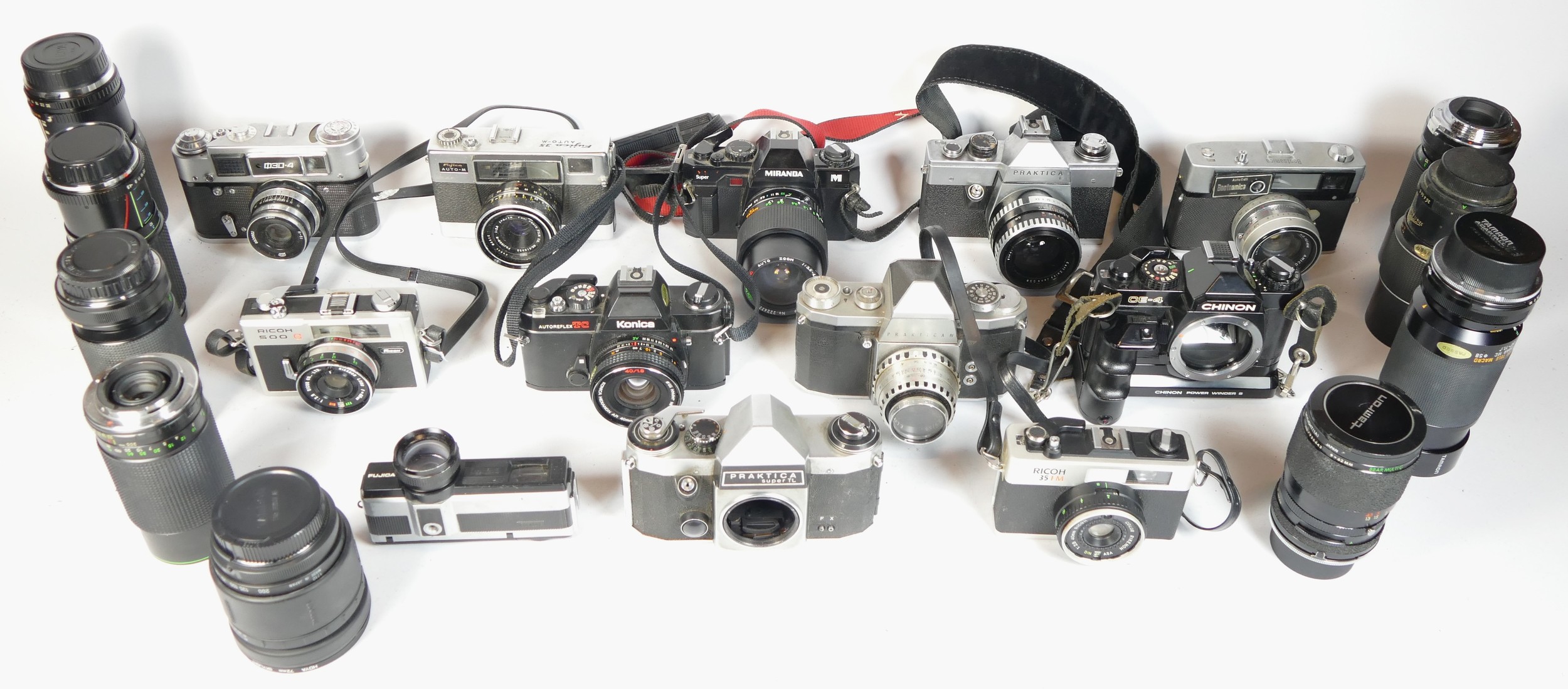 Twelve SLR vintage film cameras to include a Konica TC, a Fujica 350z, a Ricoh 35FM and a Praktica