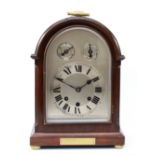 An early 20th century mahogany bracket clock, having arched architectural case, silvered dial and