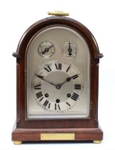 An early 20th century mahogany bracket clock, having arched architectural case, silvered dial and