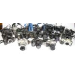 Twenty three SLR vintage film cameras to include a Canon EOS 500, a Nikon F50, a Minolta 5000 and