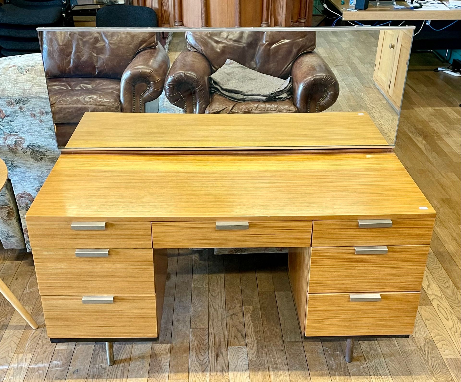 A mid 20th century Stag teak dressing table, model S.322, mirror back over central drawer flanked by