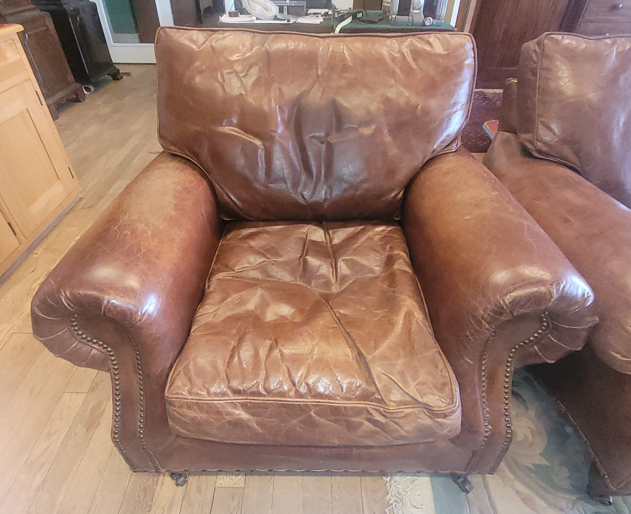 A contemporary two seater sofa upholstered in a grain tan hide leather, having drop in cushioned - Image 2 of 2