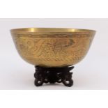 A 20th century Chinese brass singing bowl, engraved border with dragons in clouds, character mark to