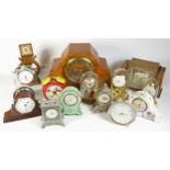 A collection of mid 20th century and later mantel clocks, alarm clocks and barometers, in three