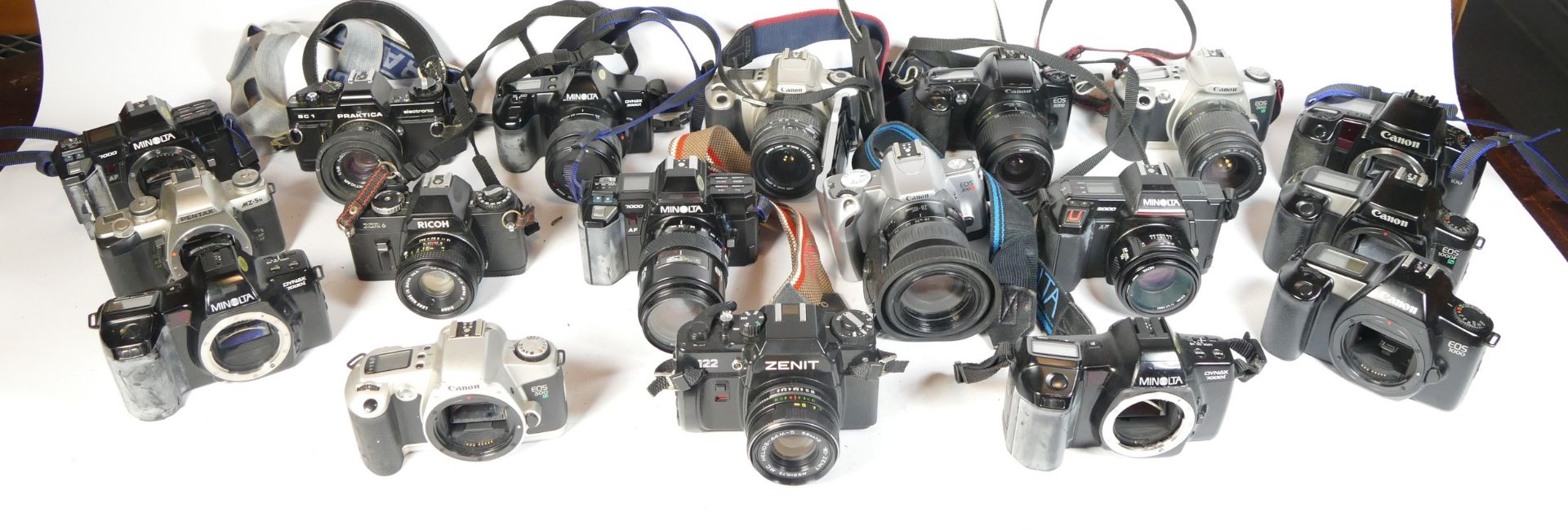 Twenty four SLR vintage film cameras to include a Canon EOS 500N, a canon EOS 3000, a Minolta