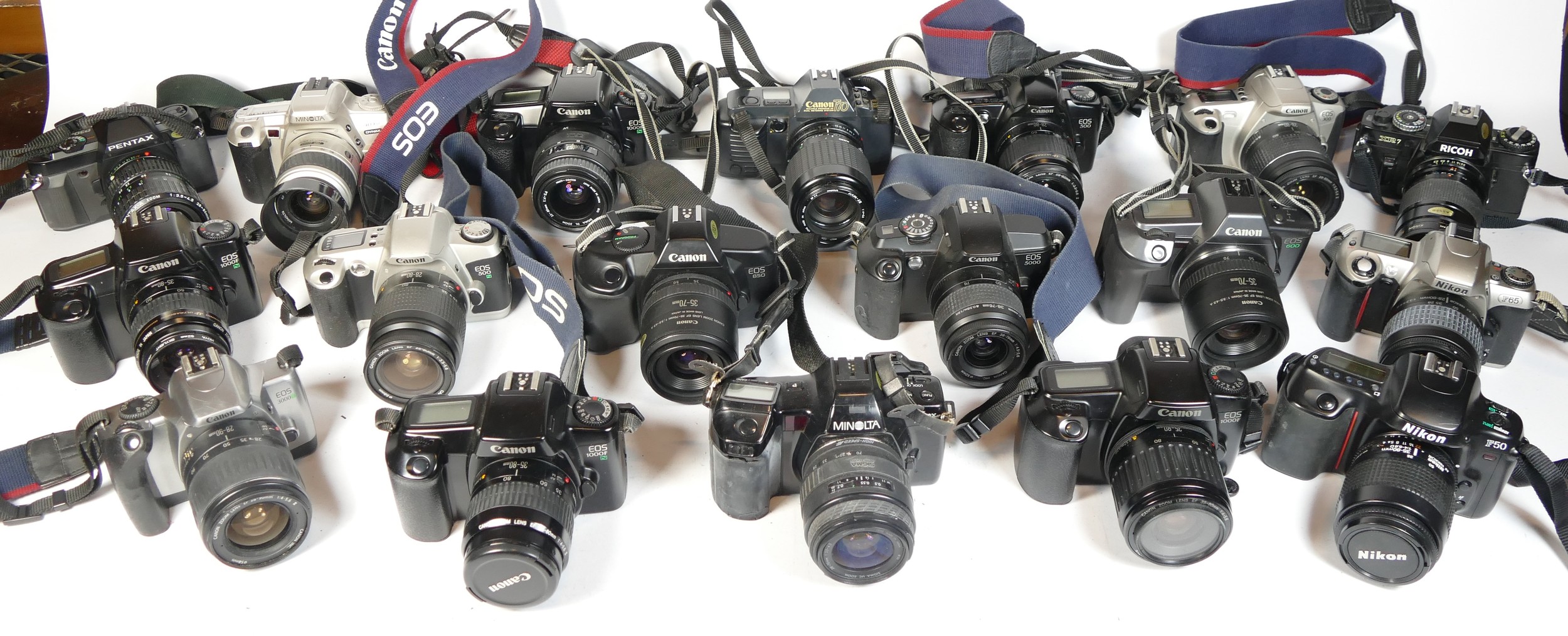 Twenty five SLR vintage film cameras to include a Nikon F65, a Canon T70, a Canon EOS 300 and a