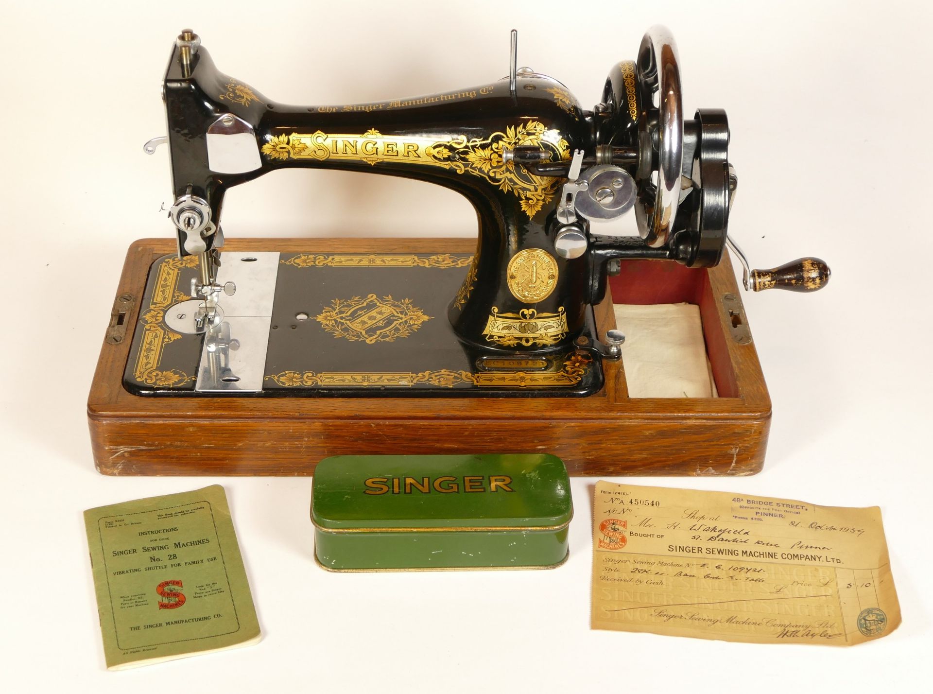 A manual operated Singer sewing machine, circa 1939, model EC109721, cased with key, instructions