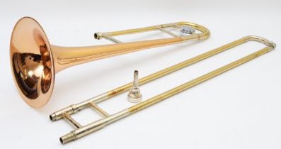 A cased trombone 'Artist' stamped C.G Conn Ltd U.S.A.