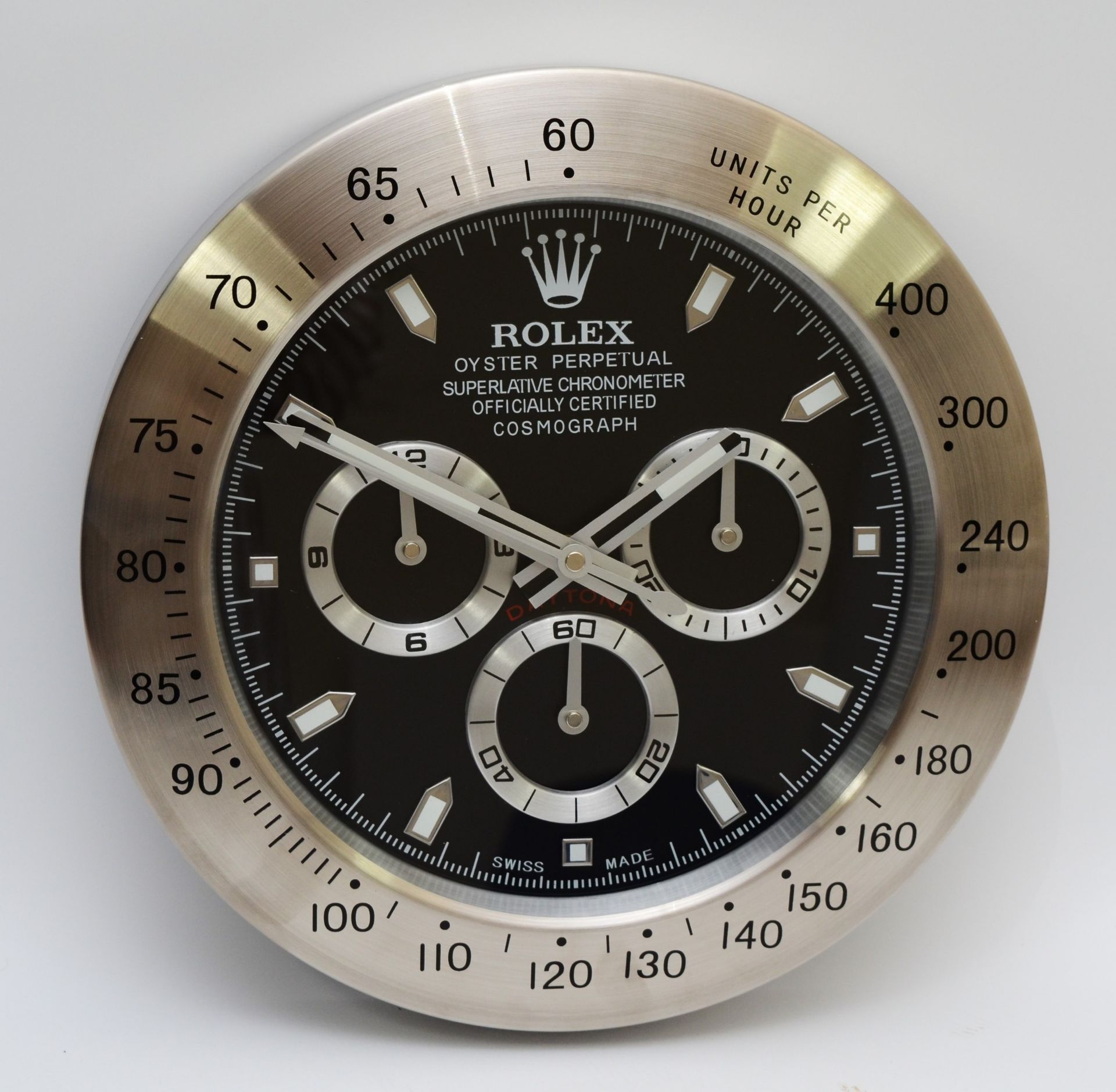 A 'Rolex' style advertising wall clock, black dial reads 'Rolex Oyster Perpetual Daytona' quartz