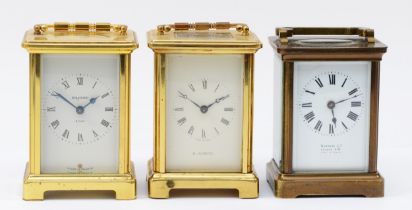 Three French 8 day carriage clocks, brass cased with enamelled dials and Roman numerals. (3)