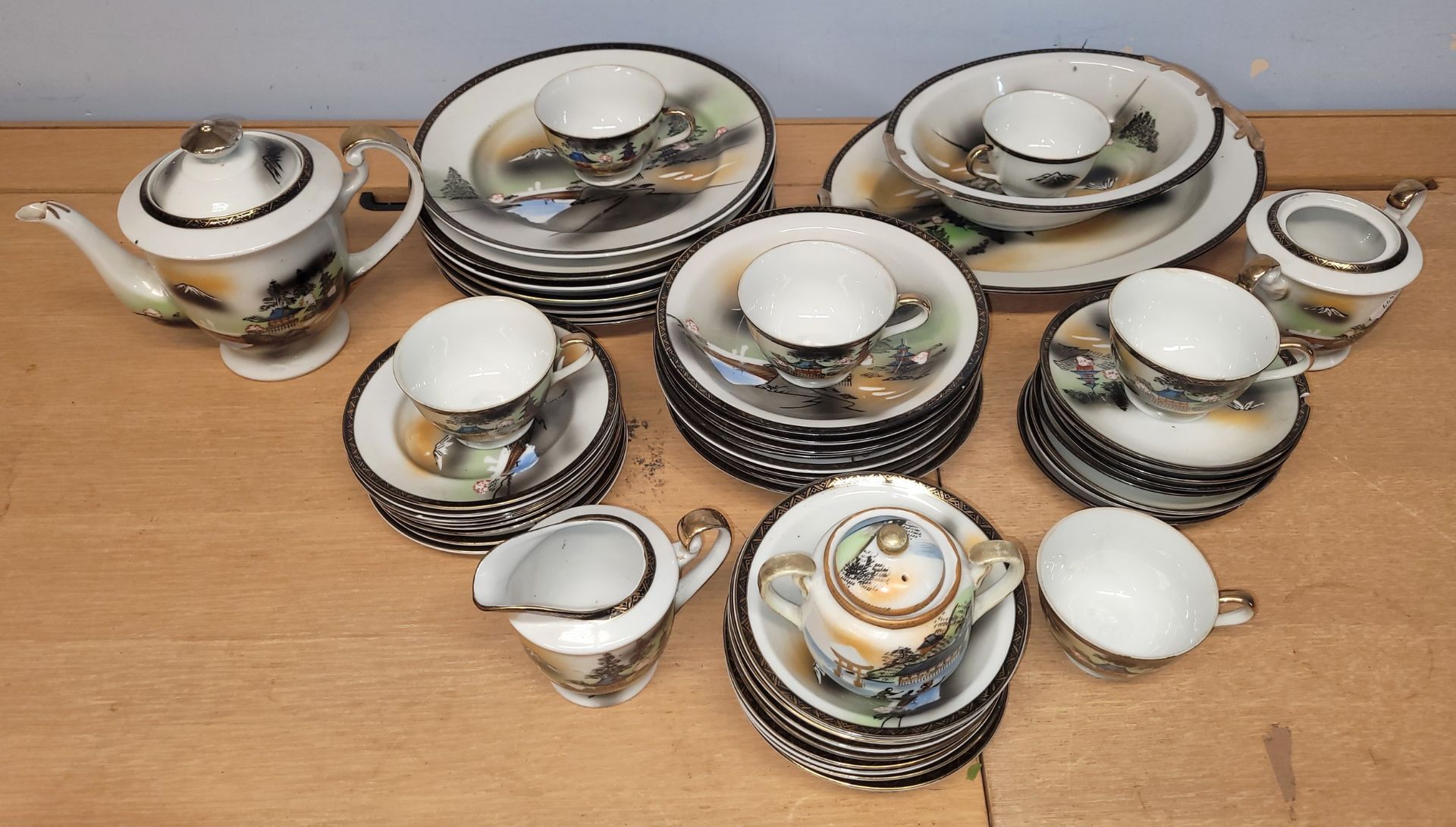A forty piece Japanese egg porcelain tea/dinner service, circa 1930s, hand painted with landscape