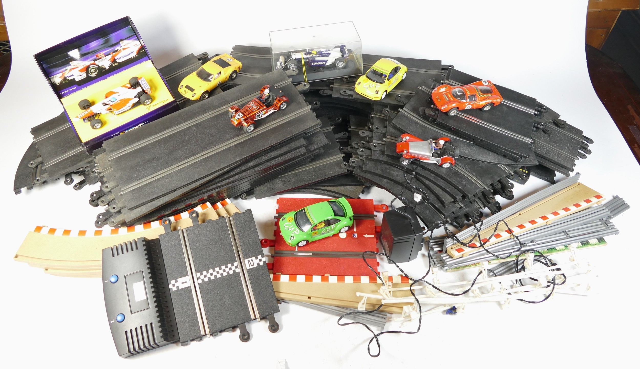 A collection of Scalextric model racing parts, track, and cars.