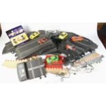 A collection of Scalextric model racing parts, track, and cars.