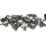 Twenty four SLR vintage film cameras to include a canon EOS 1000f, a Pentax MZ 50, a Canon EOS 500