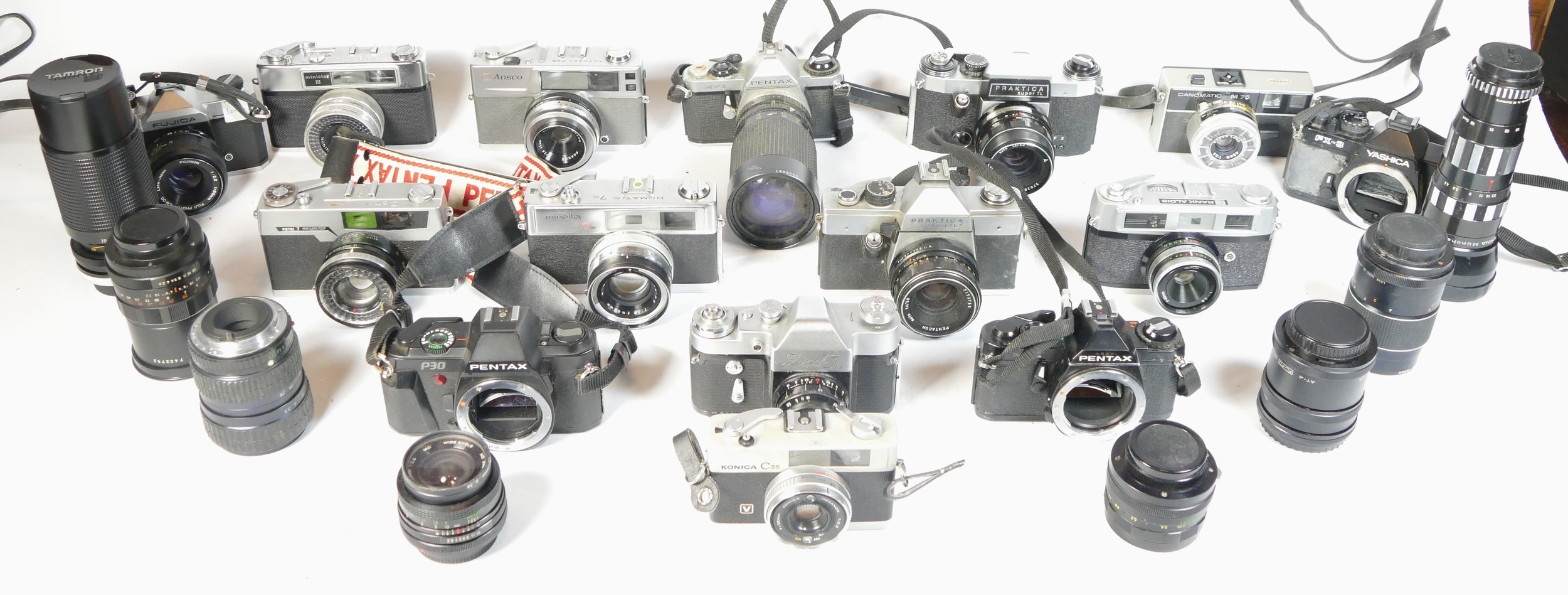 Fifteen SLR vintage film cameras to include a Yashica FX3, a Pentax MV1, a Canon M70 and a Minolta