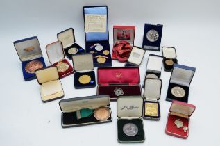 A substantial collection of medallions, primarily sporting related, silver plated, gold plated and