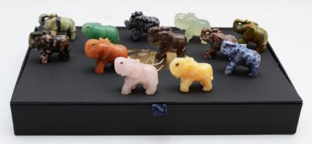 A set of twelve hand carved gemstone, crystal and jade elephants, 4cm tall, complete in presentation