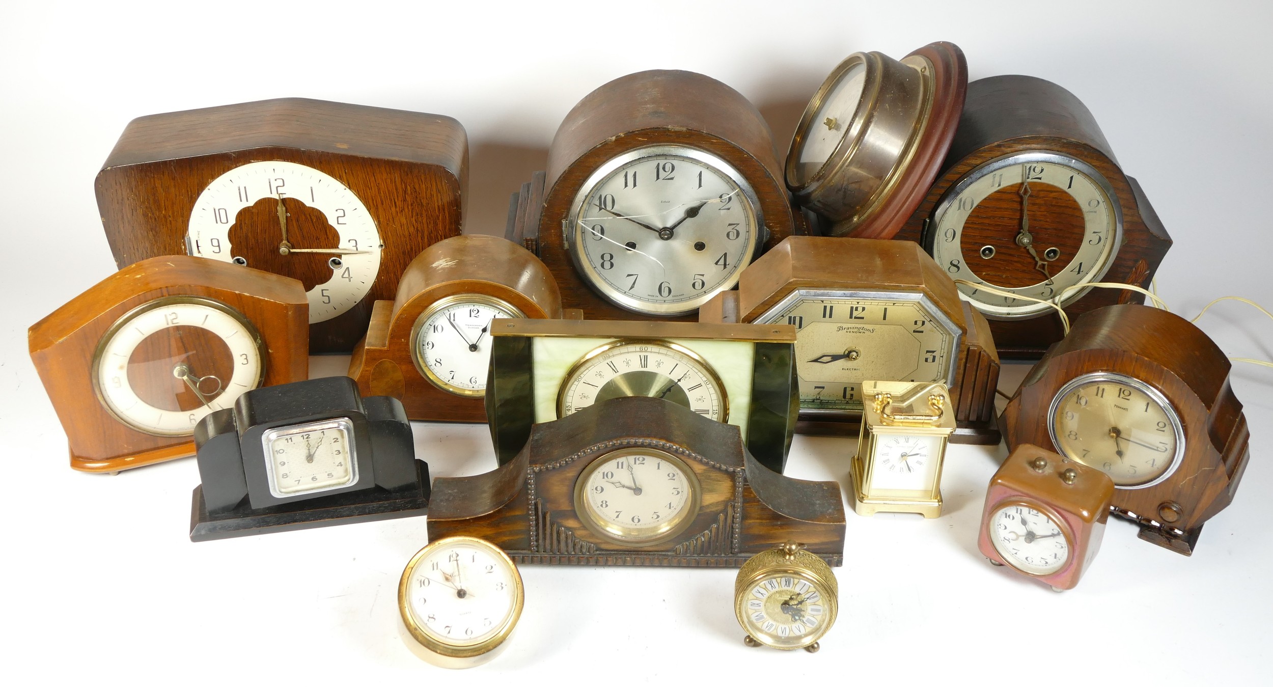 A collection of mid 20th century and later mantel clocks, alarm clocks and barometers in three