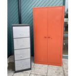 A large painted metal storage cabinet, stamped Triumph, the twin doors opening to five adjustable