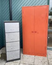 A large painted metal storage cabinet, stamped Triumph, the twin doors opening to five adjustable