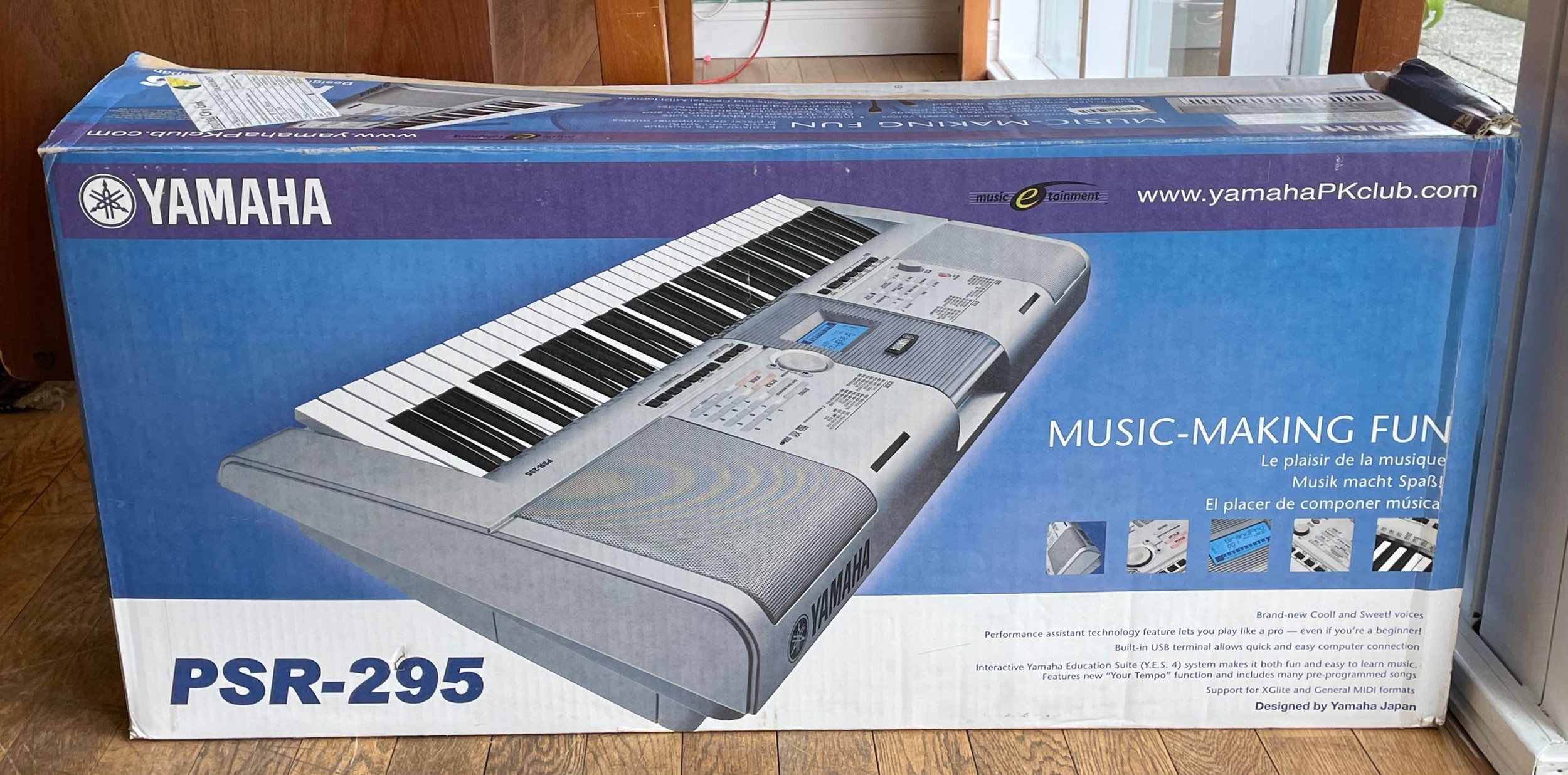 A Yamaha electronic keyboard, model PSR-295, boxed.