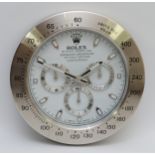 A 'Rolex' style advertising wall clock, white dial reads 'Rolex Oyster Perpetual Cosmograph
