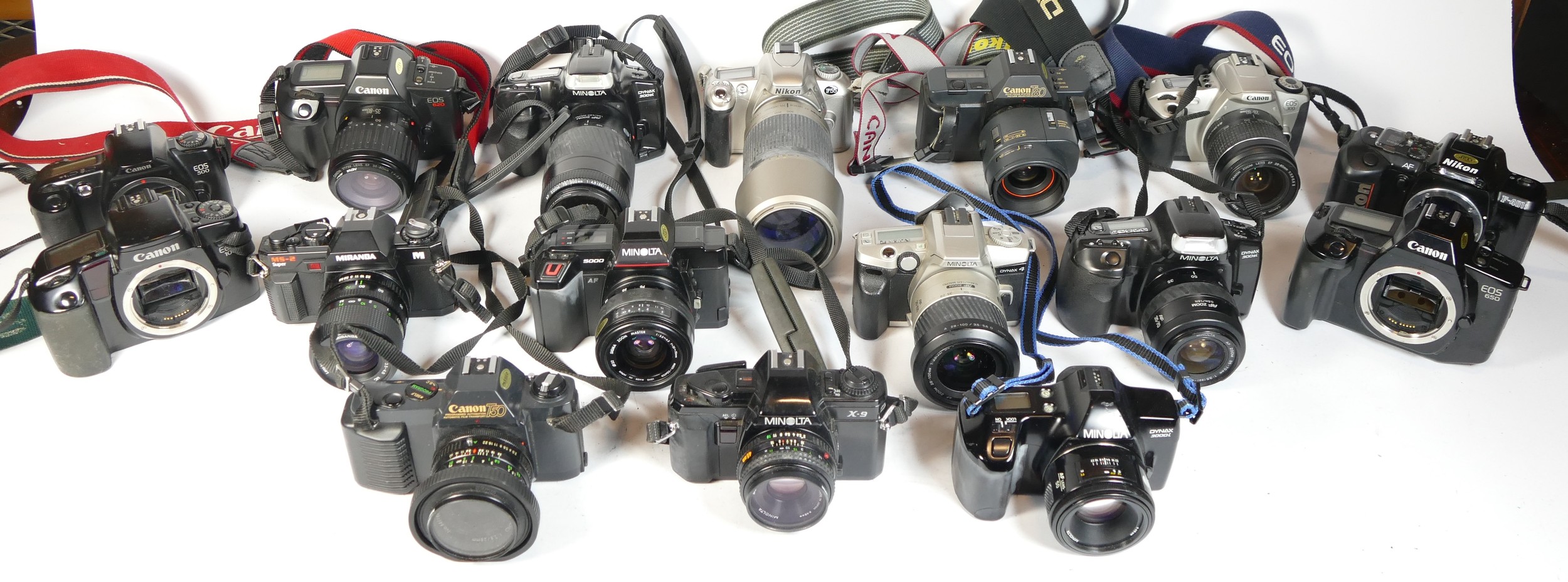 Twenty one SLR vintage film cameras to include a Minolta Dynax 4, a Nikon F55, a Canon T80, and a