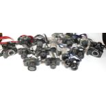 Twenty one SLR vintage film cameras to include a Minolta Dynax 4, a Nikon F55, a Canon T80, and a