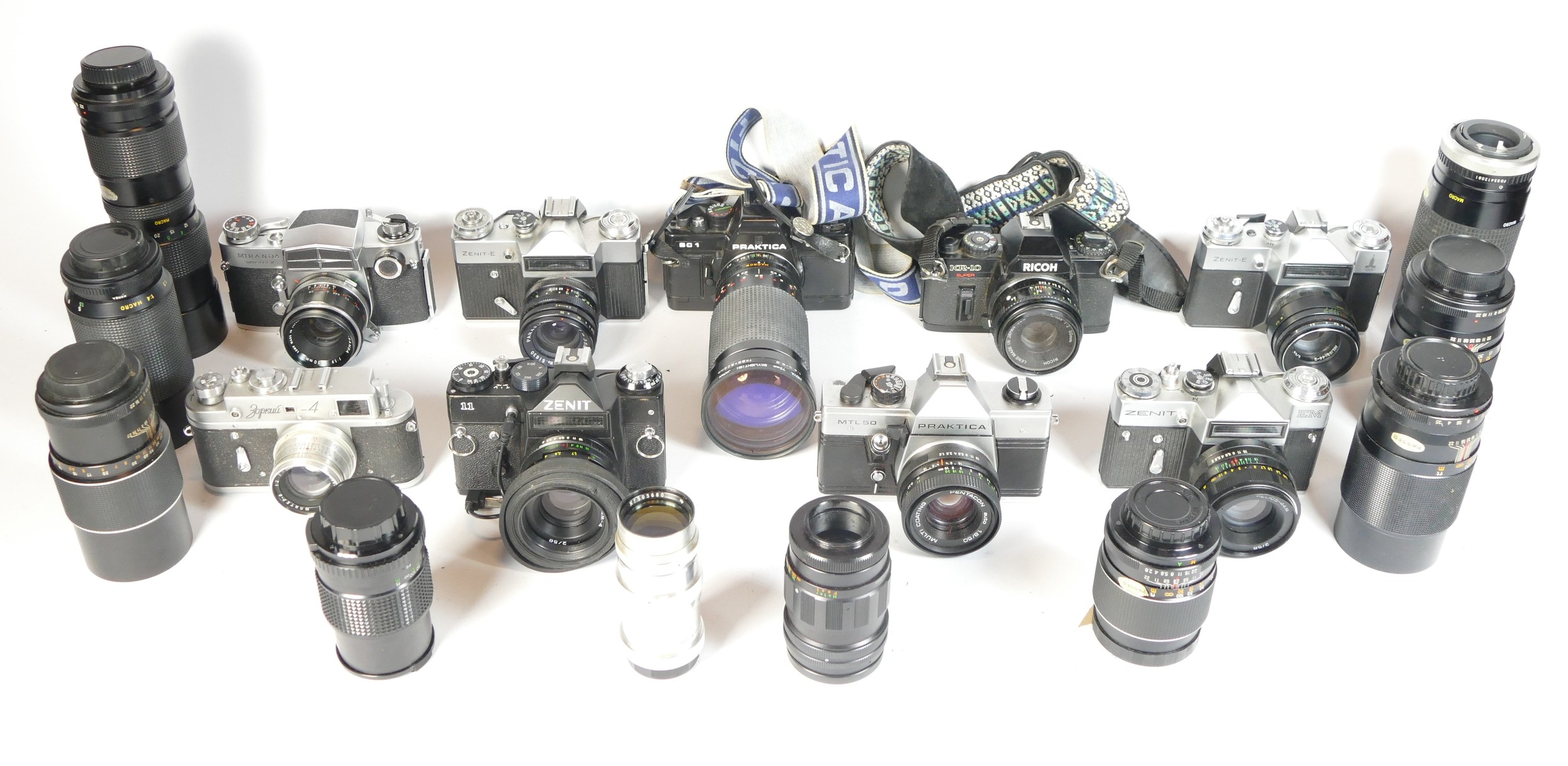 Eight SLR vintage film cameras to include a Zenit E, a Praktica BC1, a Ricoh KR10 and a Zenit II.