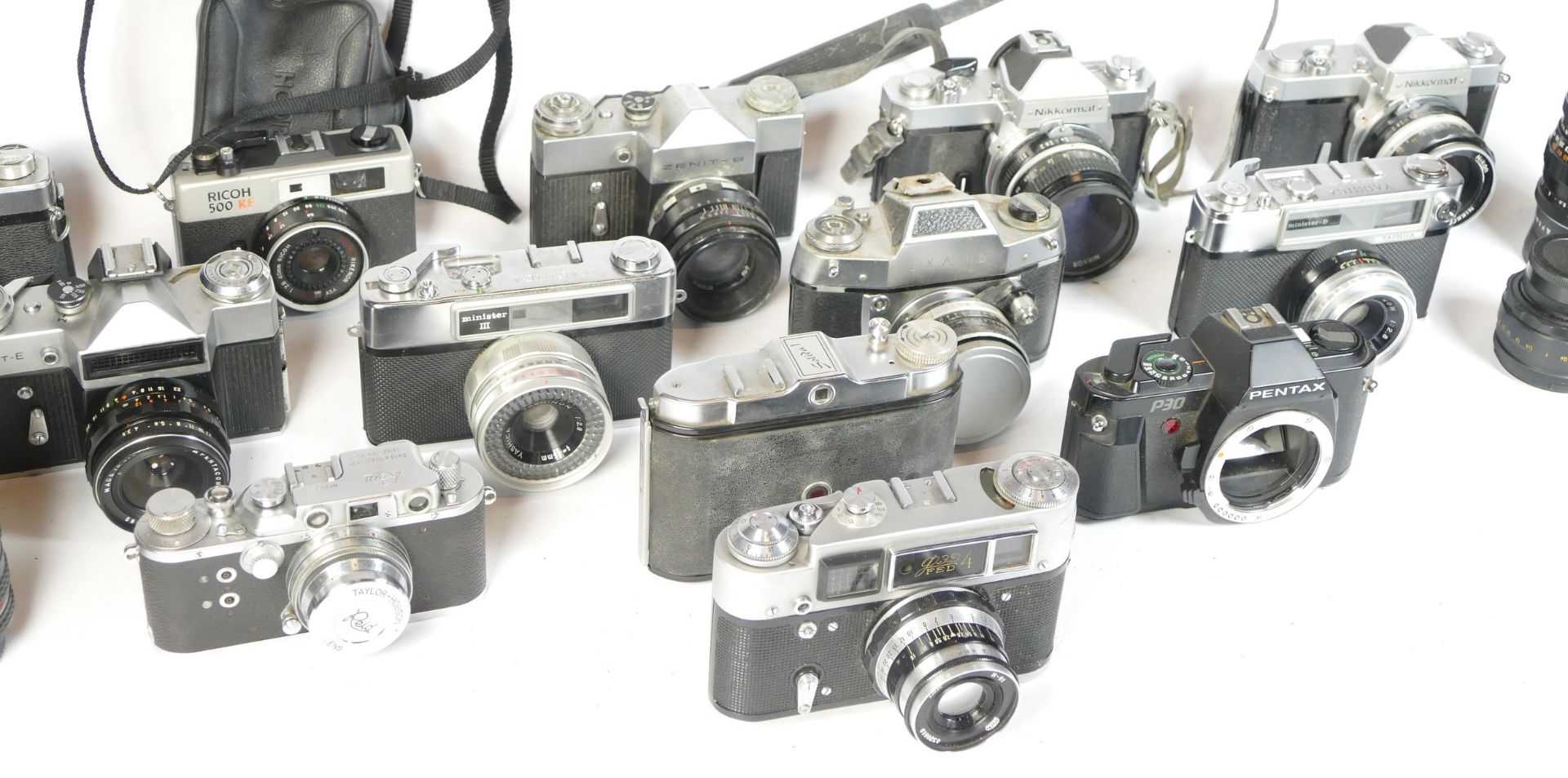 Thirteen SLR vintage film cameras to include a Zenit B, an EXA IIb, a Kowa SE, and a Ricoh 500RF. - Image 2 of 3