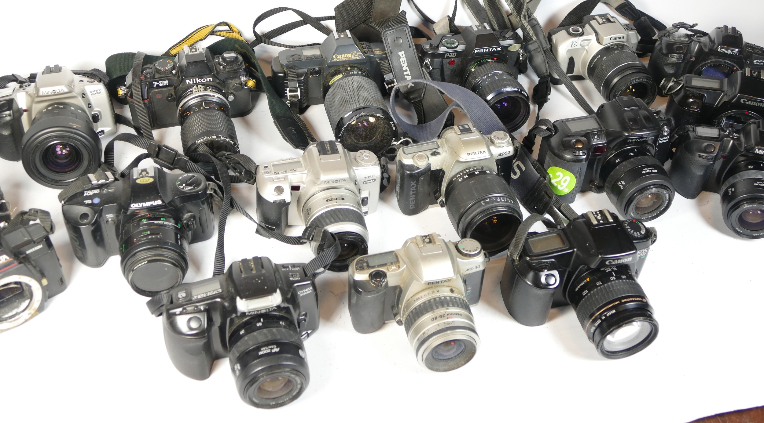 Thirty SLR vintage film cameras to include a Pentax P30, a canon EOS 1x7, a Minolta 505si, and a - Image 2 of 2