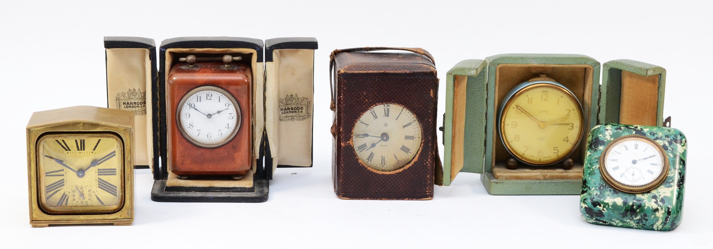 A collection of five bedside/traveling clocks, circa 1920s-50s, having manual wind movements,