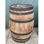 A large bound coopered oak barrel. H87, D55cm.