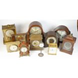 A collection of mid 20th century and later mantel clocks, alarm clocks and barometers in three