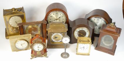 A collection of mid 20th century and later mantel clocks, alarm clocks and barometers in three
