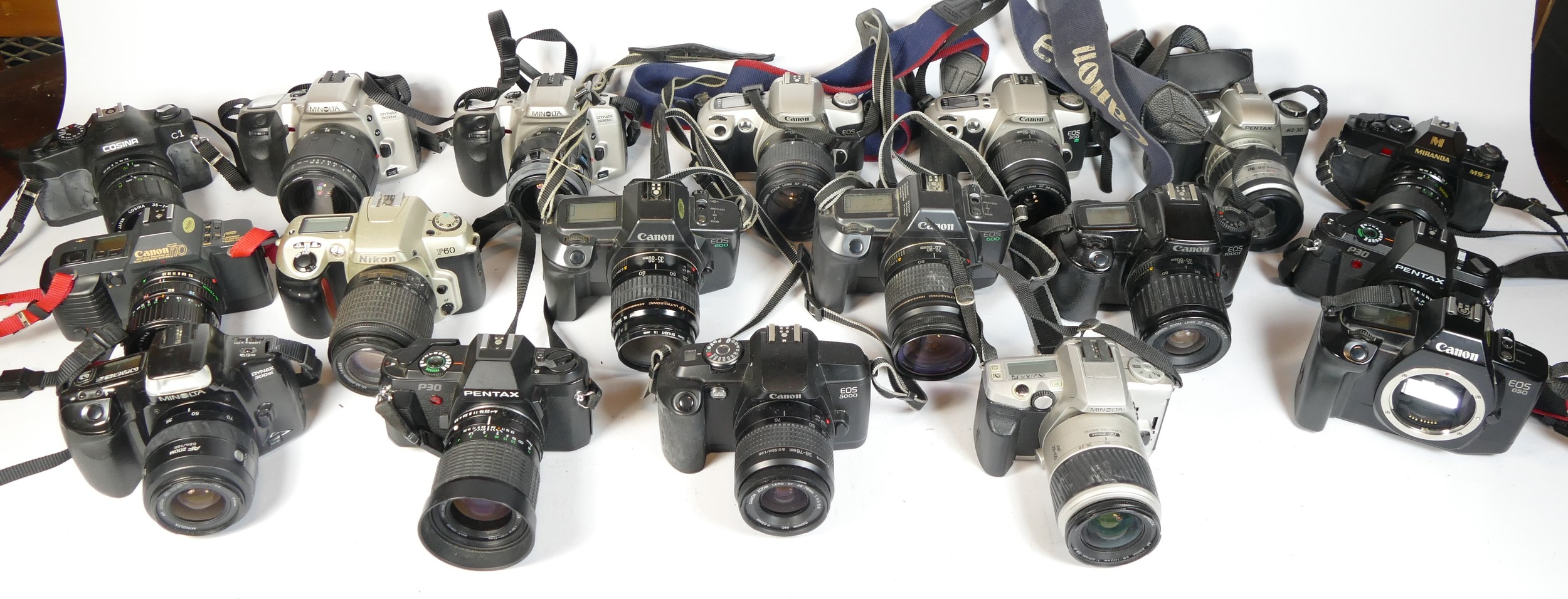 Twenty five SLR vintage film cameras to include a Canon EOS 5000, a Nikon F60, a Cosina C1 and a