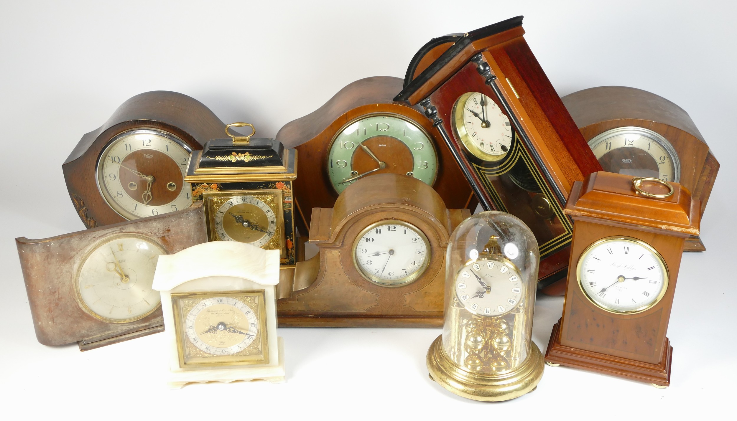 A collection of mid 20th century and later mantel clocks, alarm clocks and barometers in three