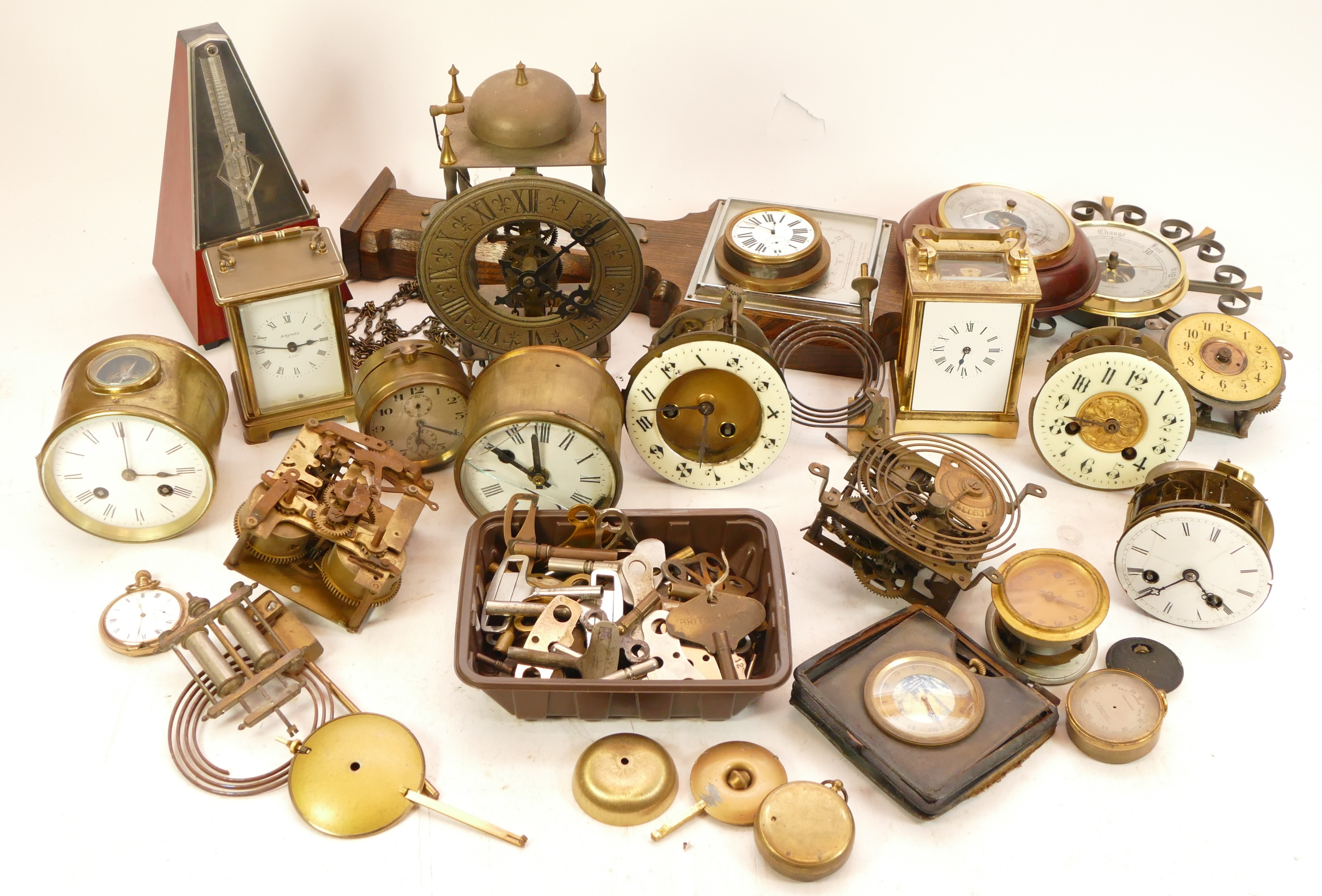 A collection of mechanical clock parts, together with quantity of various sized clock keys.