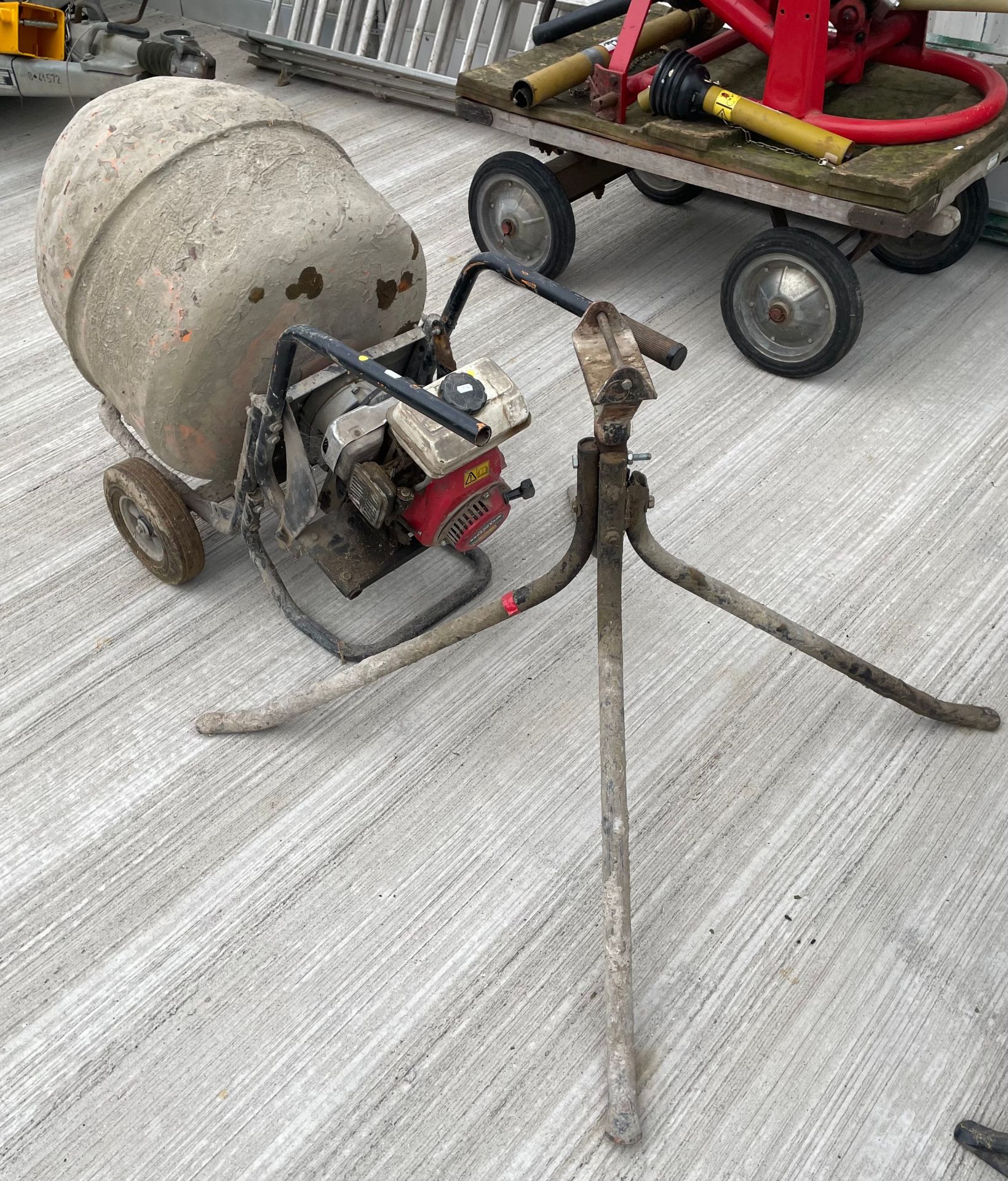 A cement mixer with Honda G100 2.5 petrol engine on stand.