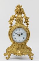 A 20th century Italian gilt metal Rococo style mantel clock, the bombe shaped leaf swept case