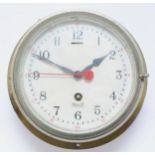 A 20th century ships bulkhead clock, the brass and nickel plated case with painted dial inscribed
