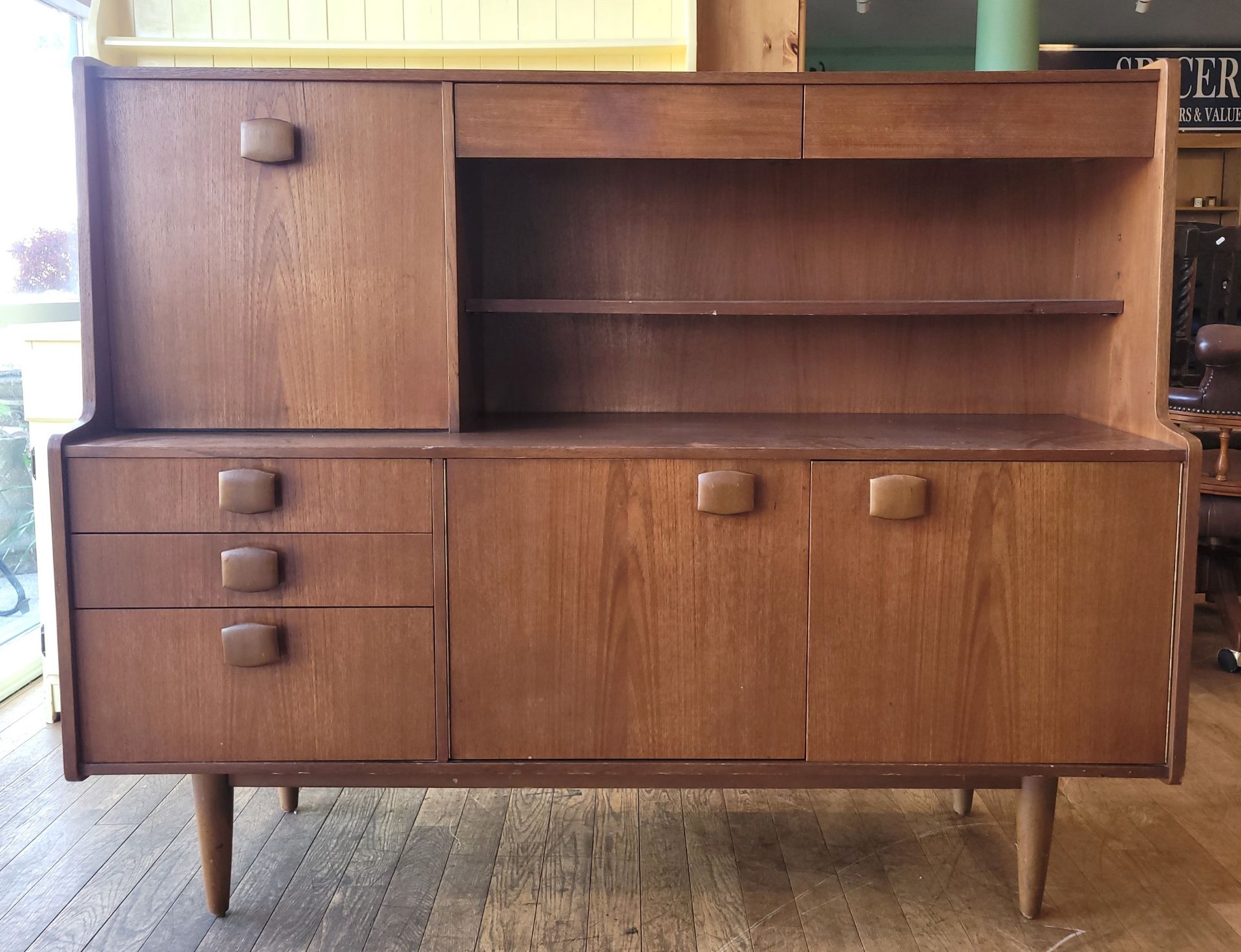 Stonehill Furniture: A mid 20th century teak sideboard/drinks cabinet. W152, H121, D45cm.