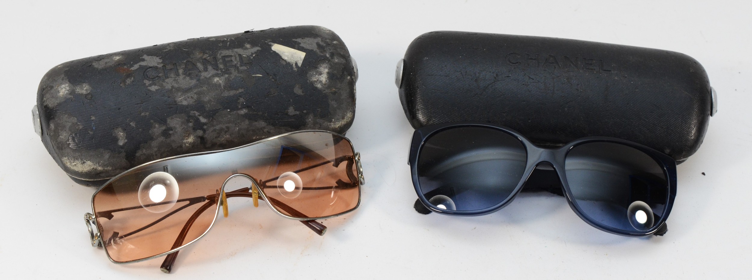 Two cased pairs of ladies vintage Chanel sunglasses.